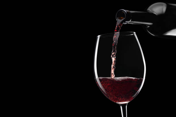 istock red wine pouring in glass from bottle isolated 1366536437