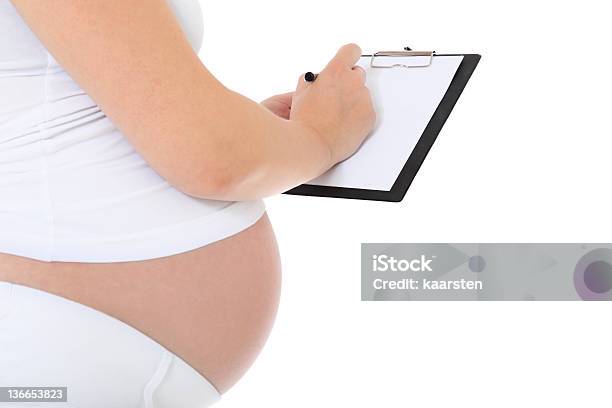 Pregnant Woman Wiritng On Clipboard Stock Photo - Download Image Now - Adult, Clipboard, Cut Out