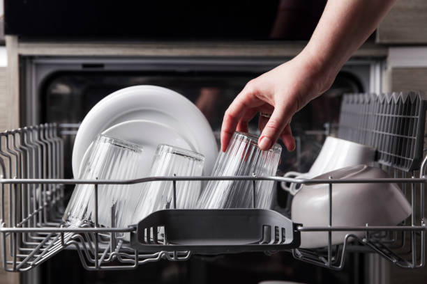 open dishwasher with clean cutlery, glasses, dishes inside in the home kitchen - diskmaskin bildbanksfoton och bilder