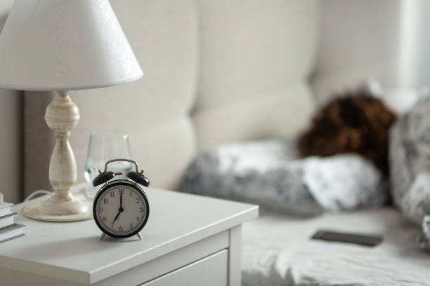 istock Alarm clock on the bedside table in the bedroom 1366539099