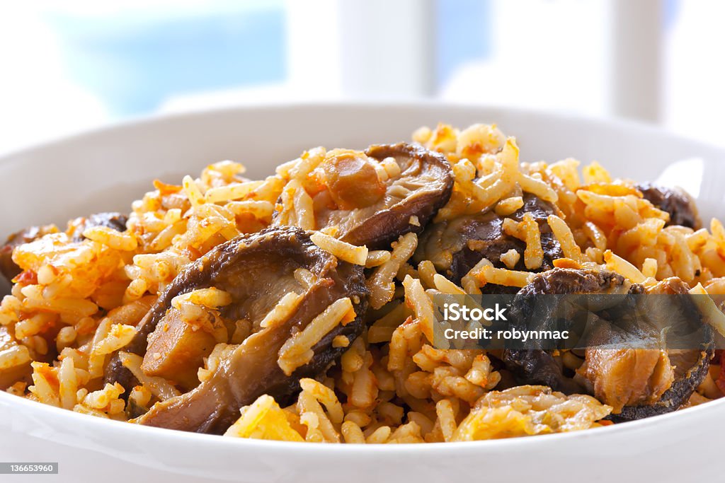 Rice with Shitake Mushrooms. Rice with shitake mushrooms.  This is West African jollof rice.  Delicious, healthy eating. Rice - Food Staple Stock Photo