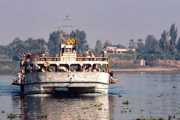 Aswan, Egypt - September 7. 2001:  Tourists crossing the Nile from Elephantine Island to  Aswan City by using the hotel ferry boat.