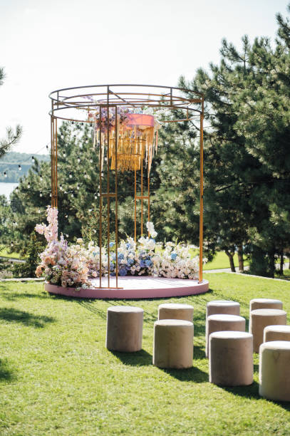 istock Trendy arch for a wedding ceremony with soft puffs for guests 1366543005