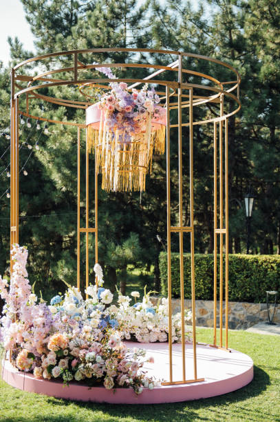 istock Trendy arch for a wedding ceremony with soft puffs for guests 1366543024