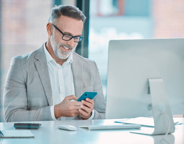 istock Shot of a businessman using a cellphone at work in a office 1366545366