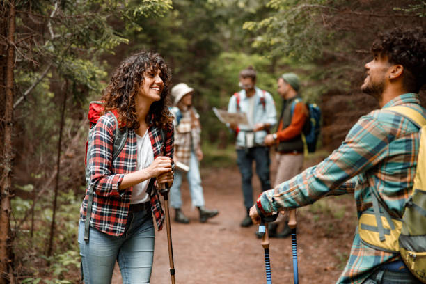 istock Happy hikers talking on a break in forest. 1366547285