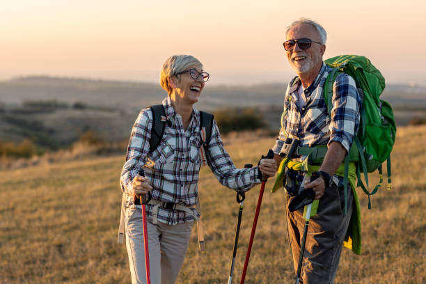 istock Old couple walking in nature and talk at sunset 1366547590