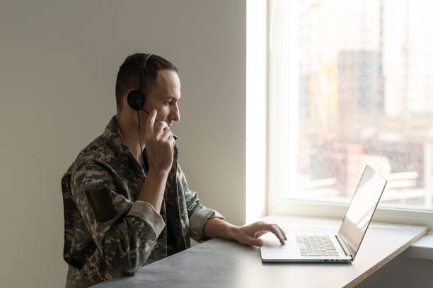 istock Soldier working with laptop in headquarters building 1366548881