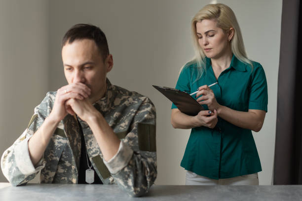 istock Soldier sitting on the sofa during psychological therapy 1366549169
