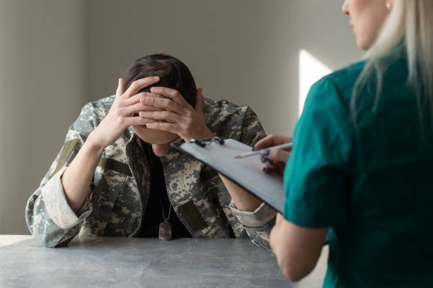 istock Soldier sitting on the sofa during psychological therapy 1366550719