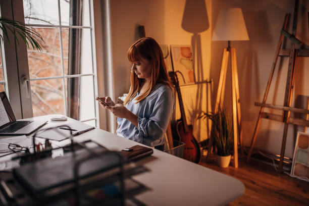istock Redhead woman using smart phone 1366554148