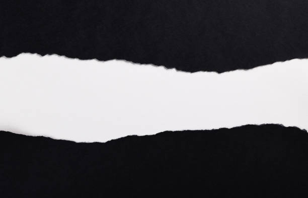 istock Black paper with torn edges isolated with white colored paper background inside. Good paper texture 1366554370