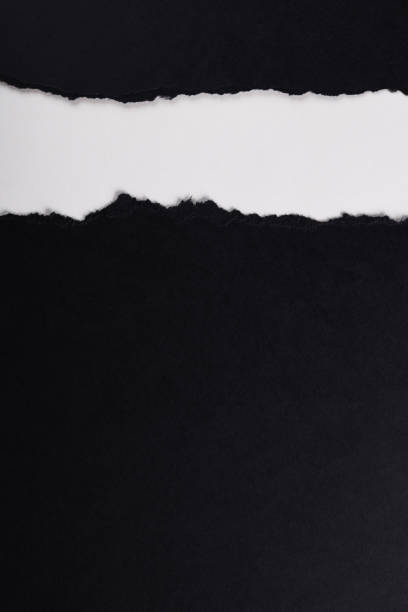 istock Black paper with torn edges isolated with white colored paper background inside. Good paper texture 1366554395