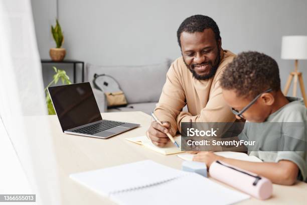 African American Boy Studying With Father At Home Stock Photo - Download Image Now - Homework, Parent, Child