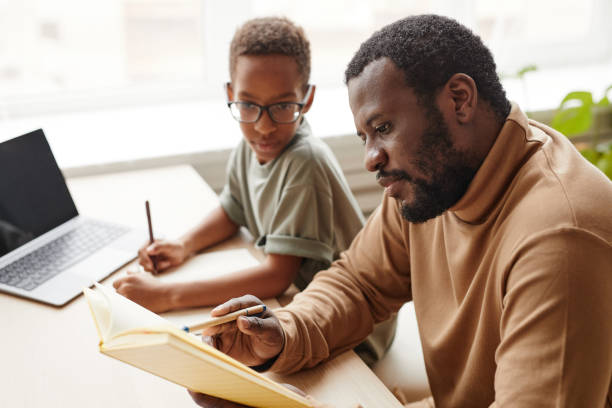 istock African American Father Teaching Son at Home 1366555017