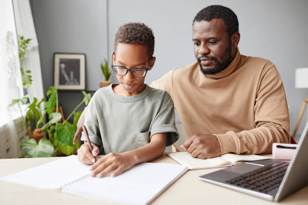 istock Father Homeschooling Son 1366555121