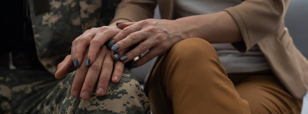 istock Offended military officer and girlfriend sitting on sofa, relationship problems 1366555182