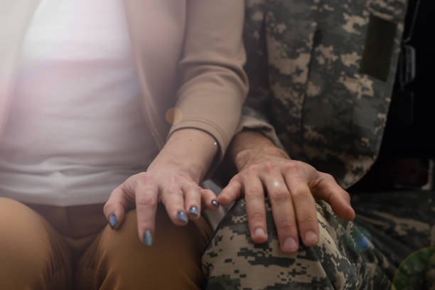 istock Offended military officer and girlfriend sitting on sofa, relationship problems 1366555313