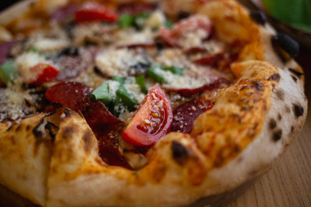 istock delicious fresh pizza with salami, basil and tomatoes 1366556746