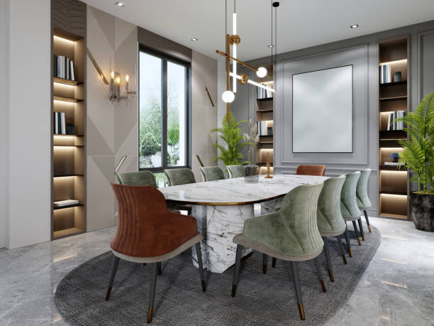 istock Luxurious dining room with a large marble table and ten different colored chairs with shelves for decor and a beige and green wall with a painting. 1366557574