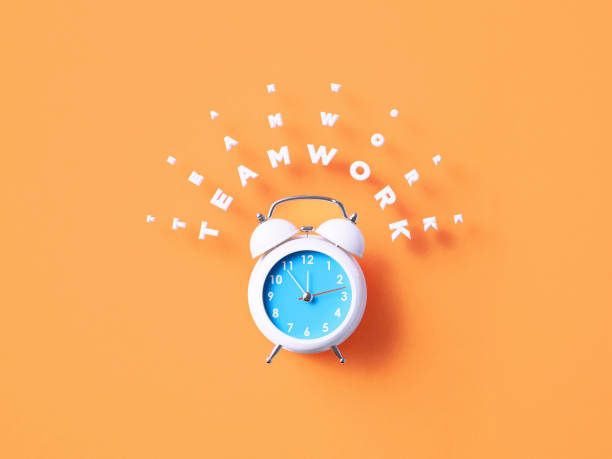 istock Teamwork Message Sitting Above White Alarm Clock On Orange Background 1366558626