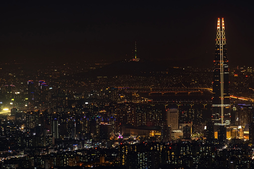 Aerial View of Iconic Lotte Tower  and Seoul Tower at the distance with Downtown Seoul, South Korea.