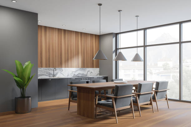 istock Dark kitchen interior with table and seats, wooden floor and window 1366561206