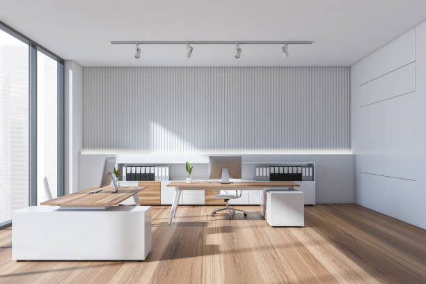istock Bright office room interior with two desks, comfortable armchairs, desktops 1366561383
