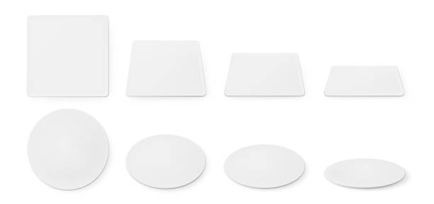 Realistic white paper coasters for beer mug White paper coasters for beer mug. Vector realistic mockup of blank square and circle beermat in top view. Bierdeckel for cup or cardboard mat different shapes and angles isolated on white background. restaurant table side view stock illustrations