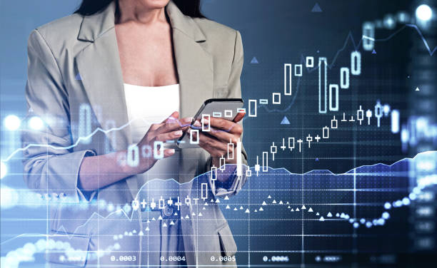 istock Businesswoman with phone in hands, graph changes with candlesticks 1366562771