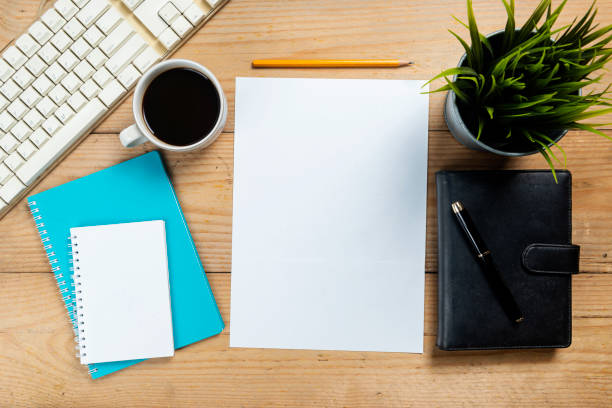 istock Empty paper with pencil and coffee cup on wooden desk 1366564160