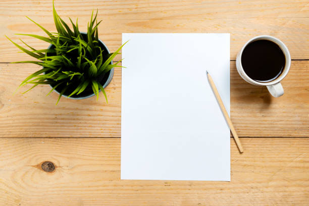 istock Empty paper with pencil and coffee cup on wooden desk 1366564192