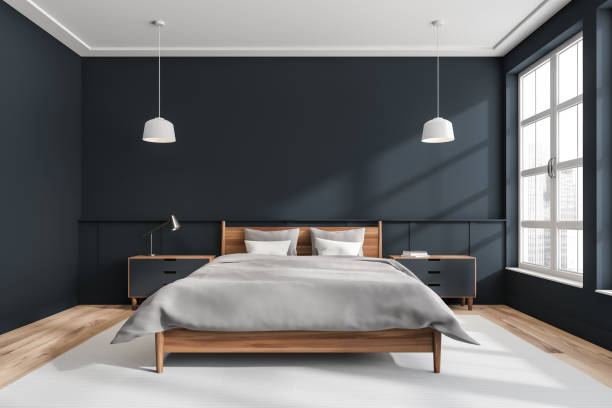 istock Dark bedroom interior with bed on grey carpet, window with city view. Mockup 1366564356