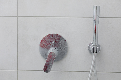 Dirty calcified shower mixer tap, faucet with limescale on it, plaque from water, Chrome-plated shower, close up photo