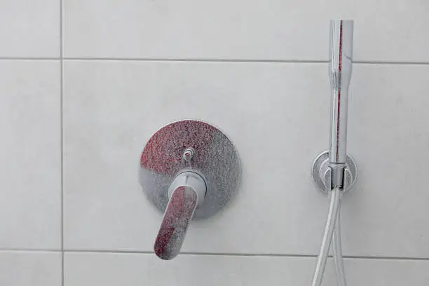Photo of Dirty calcified shower mixer tap, faucet with limescale on it, plaque from water, Chrome-plated shower, close up photo