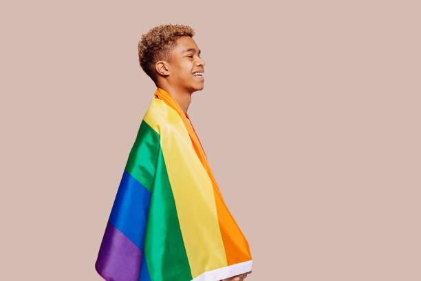 istock Young afro black latin man with a gay pride flag at studio 1366564823