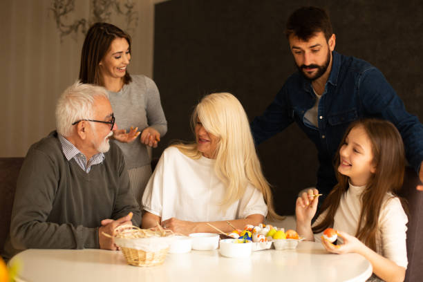 istock A family is having a great time together during preparations for Easter. They are sitting at the dining table, coloring Easter eggs. 1366565894