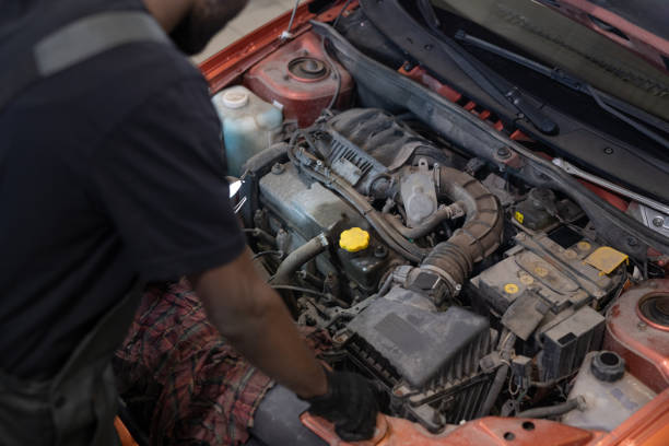 Professional mechanic working on the engine of the car in the garage stock photo