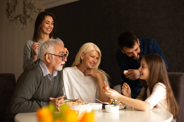 istock A family is having a great time together during preparations for Easter. They are sitting at the dining table, coloring Easter eggs. 1366565968
