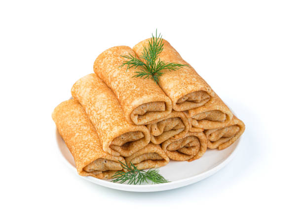 istock Stuffed thin pancakes in a white plate with dill. Side view, close-up 1366567235