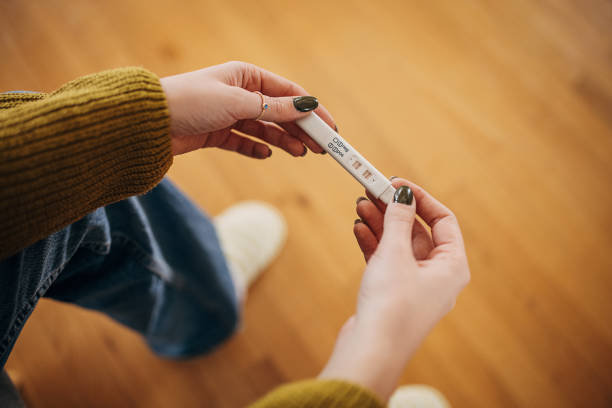 Woman holding positive pregnancy test stock photo