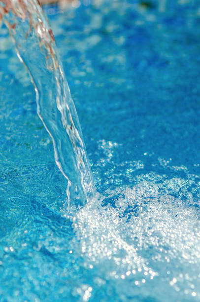 istock Stream of water falling into a pond. Purity freshness energy water. 1366567349