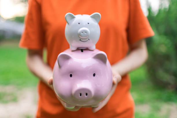 istock Holding Piggy Bank 1366568724