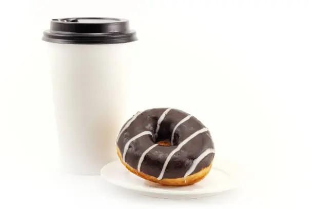 Photo of Chocolate donut and big coffee cup. Concept background of serving takeaway food for a coffee shop or bakery