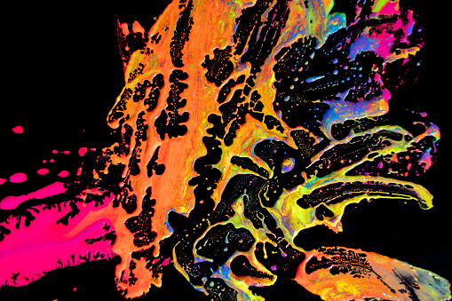 Multi-color paint drops and splotch on black background