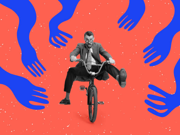istock Contemporary artwork with excited young man riding a bicycle through huge drawn blue creeping arms. 1366570673