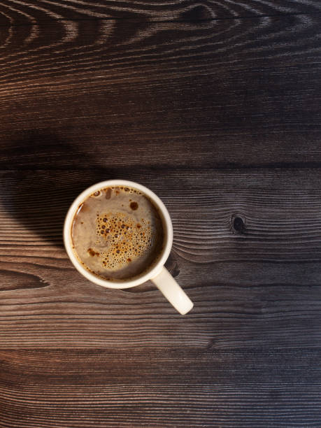 istock Coffee cup on dark wood background 1366572164