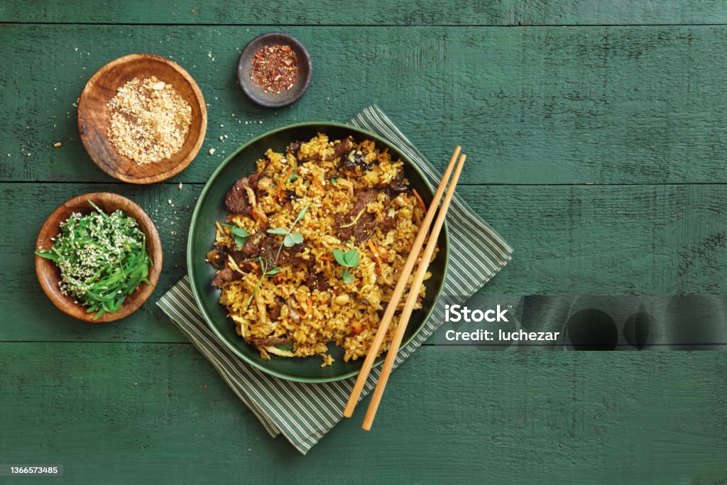 Thai Beef Fried Rice Thai Beef Fried Rice. Flat lay top-down composition on dark green background. Fried Rice Stock Photo
