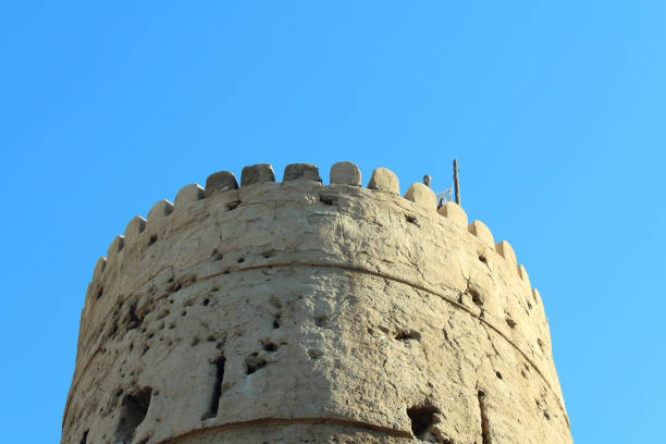 Old clay large fortress tower. Close-up. Old Dubai. stock photo