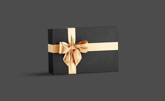 Blank black gift box with gold ribbon bow mockup, dark background, 3d rendering. Empty flat carton packaging for dress present mock up, side view. Clear creative festive container template.